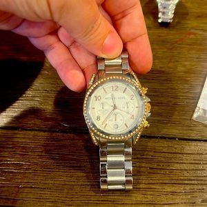 Michael kors silver and rose gold with stones around the face of the watch